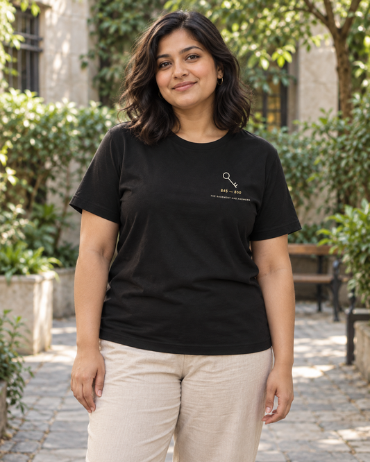 AI-generated lifestyle mockup of Basement Archive Minimalist Anime Soft Tee in black on an adult model