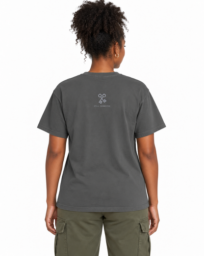 Between Worlds heavyweight tee Pepper — studio back lifestyle — back view