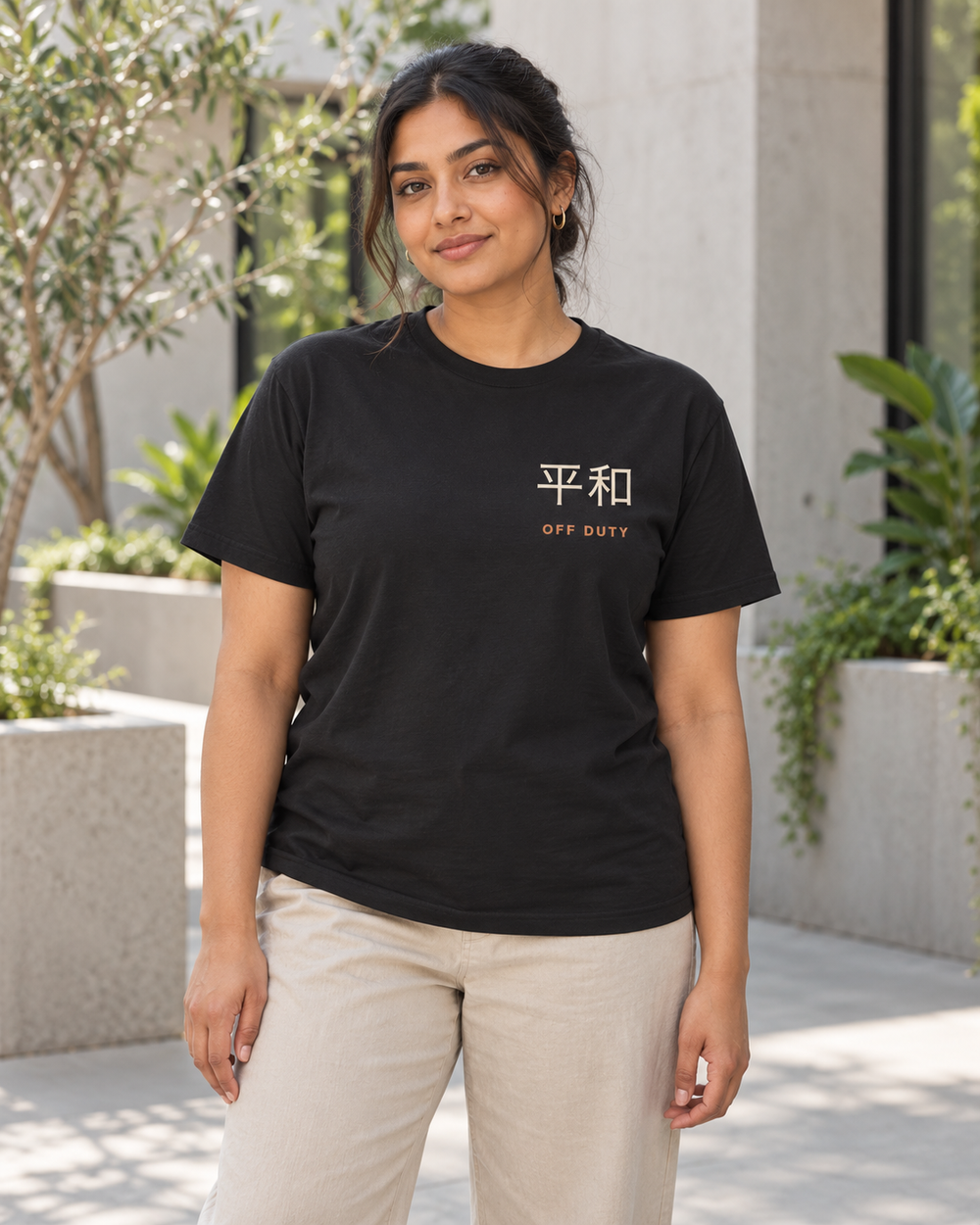 AI-generated lifestyle mockup of Off Duty Kanji Anime Soft Tee in black on an adult model