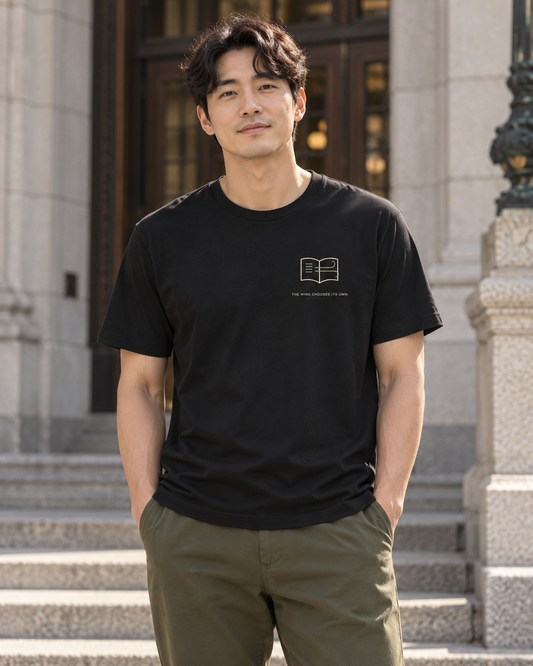 AI-generated lifestyle mockup of Wind Chooses Minimalist Anime Soft Tee in black on an adult model